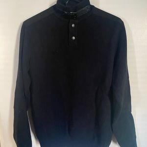 Black mock-neck sweater with faux leather collar strap